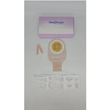 Ostomy bag kit with adhesive barrier, measuring guide, and pink accessory on white background
