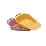 Yellow and pink plastic bedpans with handles for medical home care