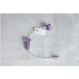 Purple extension set for medical infusion, IV connector on gray background