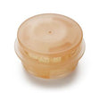 Tan plastic medical filter cap for respiratory equipment on white background