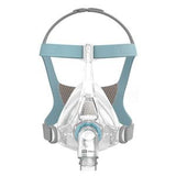 Full face CPAP mask with clear silicone cushion and adjustable blue-gray headgear for sleep apnea.