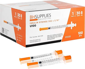 Box of insulin syringes 30G 1ml with orange caps, two syringes in front.
