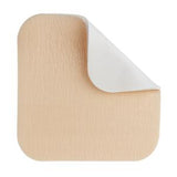 Square beige adhesive medical bandage with rounded corners and lifted edge