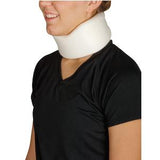 Person wearing a white foam cervical neck collar for neck support