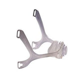Clear plastic CPAP mask frame with headgear slots on a white background