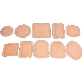Assorted beige medical adhesive dressings in various shapes and sizes on a white background