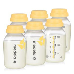 Six Medela breast milk storage bottles with yellow lids and measurement markings
