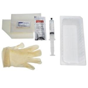 Sterile medical dressing change kit with gloves, syringe, tray, gauze, and solution packet.