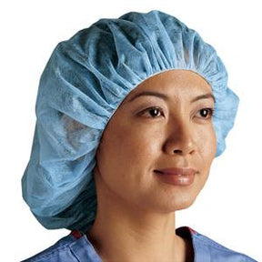 Smiling woman wearing disposable blue medical bouffant cap, clinical setting