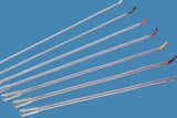 Assorted medical catheters with bent tips and color-coded ends on blue background