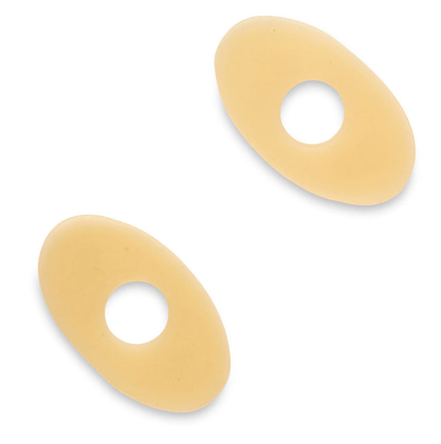 Two beige oval barrier rings with center openings, used for ostomy care supplies
