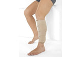Beige medical compression calf wrap on lower leg for swelling relief