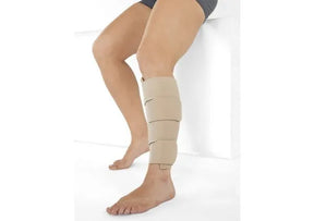 Beige medical compression calf wrap on lower leg for swelling relief