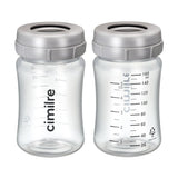 Two clear plastic breast milk storage bottles with measurement markings and grey lids