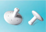 two white medical ostomy stoma plugs with air holes on a blue background