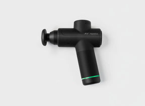 Black handheld percussion massage gun with green accent on white background