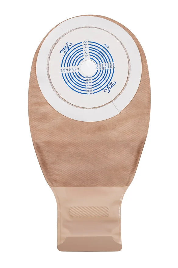 Beige medical ostomy bag with circular measurement guide and adhesive backing.