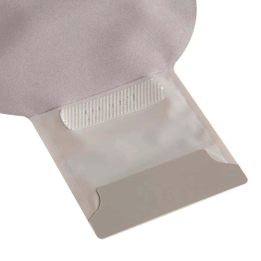 Close-up of a medical ostomy pouch with adhesive closure on a white background