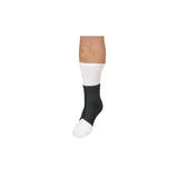 Leg wearing a white medical sock with a black ankle support sleeve, isolated on white background.