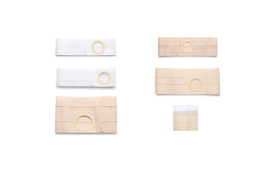 Assorted ostomy belts and support garments in beige and white on a white background
