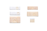 Assorted ostomy belts and support garments in beige and white on a white background