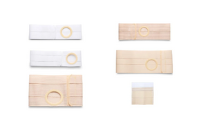 Assorted medical ostomy belts in white and beige with circular openings, displayed on white background.