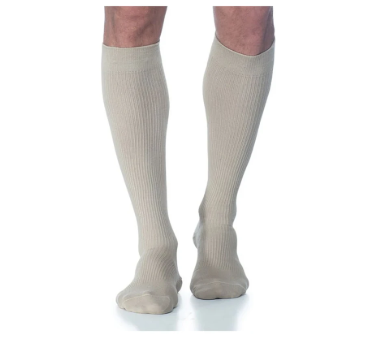 Beige knee-high compression socks worn on legs, medical support hosiery