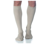 Beige knee-high compression socks worn on legs, medical support hosiery