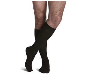 Person wearing black compression socks for leg support