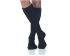 Person wearing knee-high black compression socks for medical support