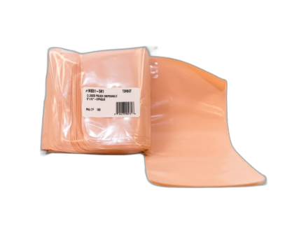Peach-colored disposable medical barrier sheets stacked with one unfolded