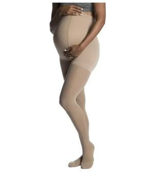 Pregnant woman wearing beige maternity compression stockings