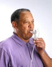 Man using a nebulizer for respiratory therapy at home