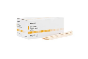 Box of McKesson wooden applicators with several applicator sticks lying next to it.