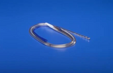 Medical urinary catheter tube on blue background, essential home healthcare supply