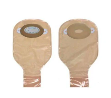 Two beige ostomy bags with adhesive baseplates on a white background, medical supplies.