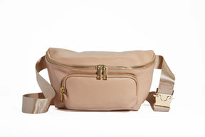 Beige waist bag with gold zippers and adjustable strap on white background