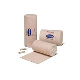 Elastic medical bandages for wound care with clips, unrolled and rolled on white background