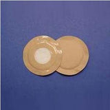 Two round beige medical adhesive bandages on a blue surface