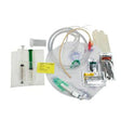 Medical catheterization kit with catheter, syringes, gloves, tubing, and accessories on white background