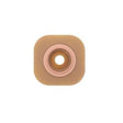 Medical ostomy barrier with adhesive, square shape and round center opening on white background