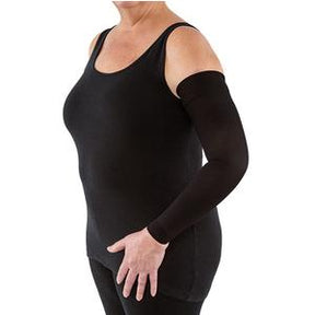 Woman wearing a black compression arm sleeve for lymphedema support