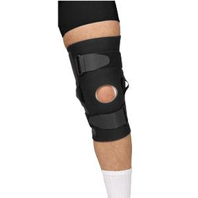 Adjustable black knee brace with open patella on person's leg, medical support device