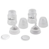 Two clear baby milk bottles with measurement markings, lids, and detachable bases on white background