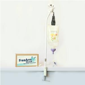 Tube feeding stand holding a nutrition bag and pump beside FreeArm Muscle device sign