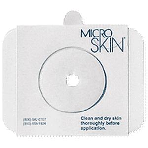 Microskin adhesive barrier ring with center hole for medical device attachment