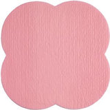 pink textured medical adhesive pad with scalloped edges on white background