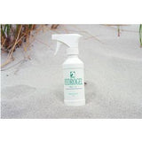 Hydrogel spray bottle for wound care on sandy beach with grass in background
