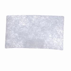 Rectangular white medical filter pad on plain background