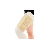 Compression wrap for thigh with adjustable beige straps on bent leg